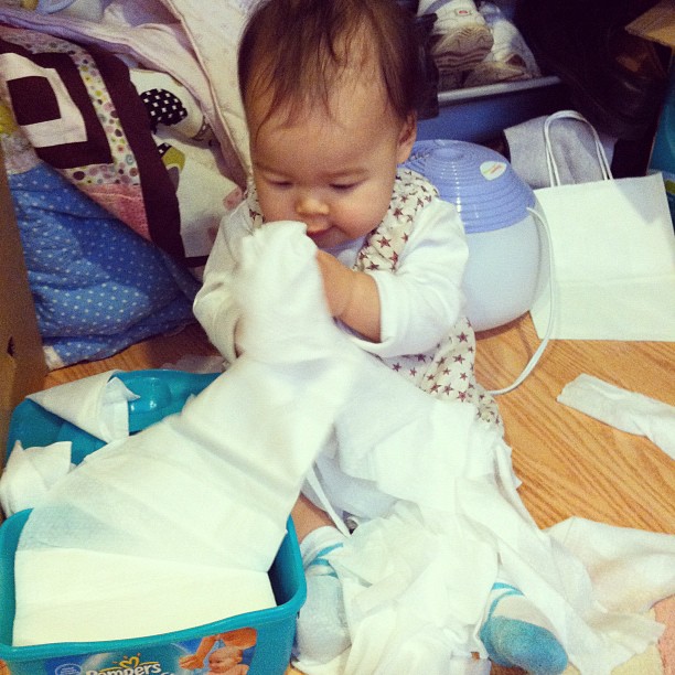 Mio playing with wipes.