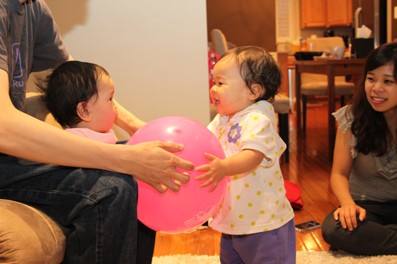 Anna and Mio playing with a ball.