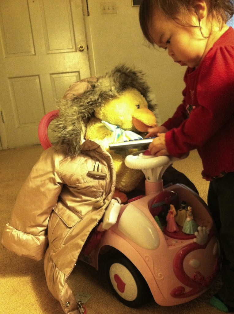 Mio putting her duck on her car.